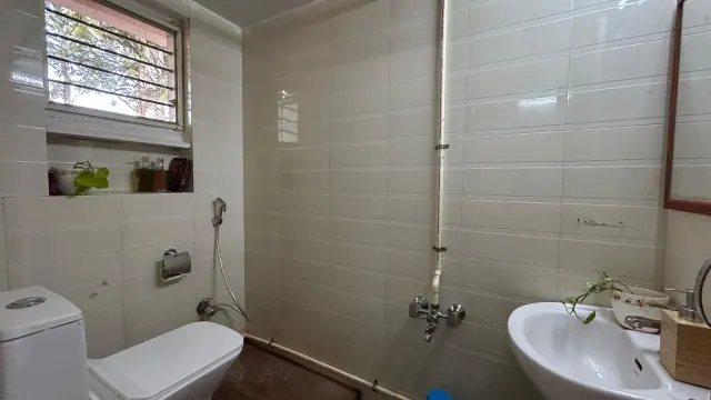 Deluxe AC Cottage — attached bathroom with washbasin and window