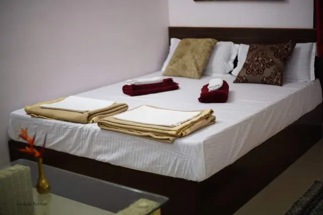 Deluxe AC Cottage — the bed made up with fresh towels