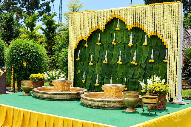 Haldi stage with banana leaves and marigold garlands