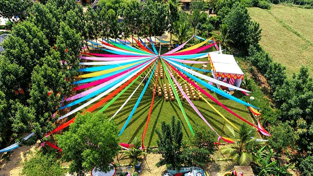 Aerial view of the rainbow ribbon canopy over the event lawn