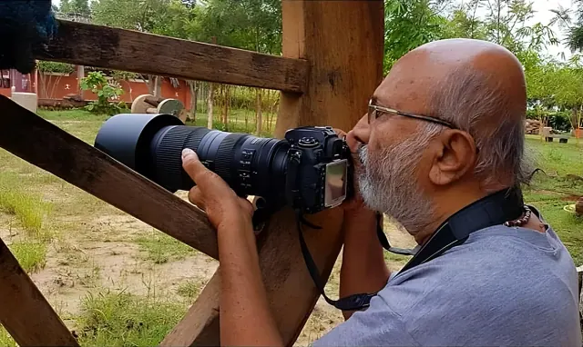 S. Shivaram photographing with a telephoto lens at Saakshi Retreat