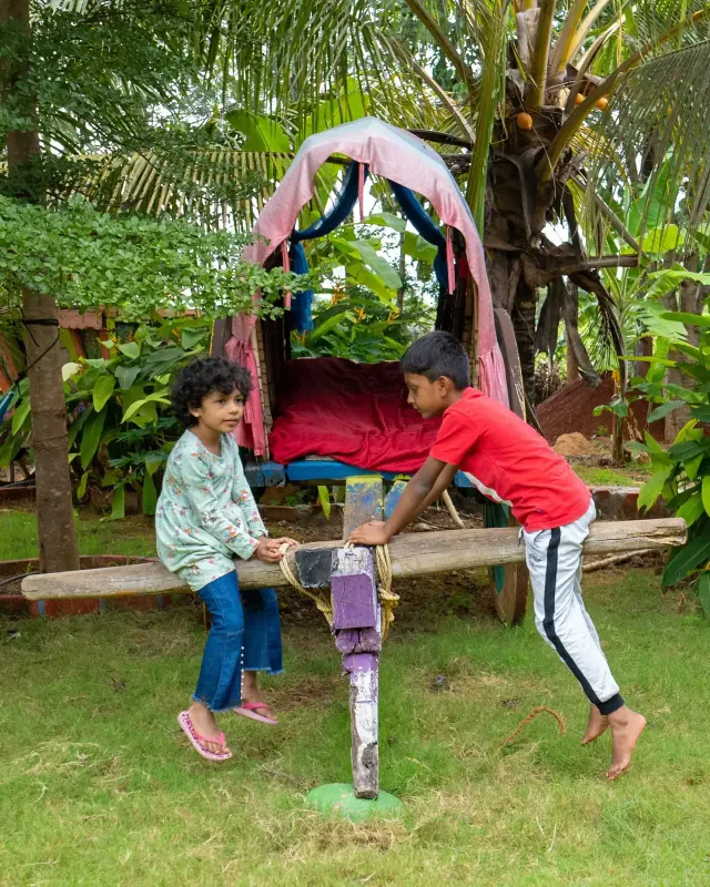Children playing on a swing