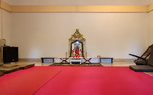 Shrine and red carpet in the Mouna meditation hall