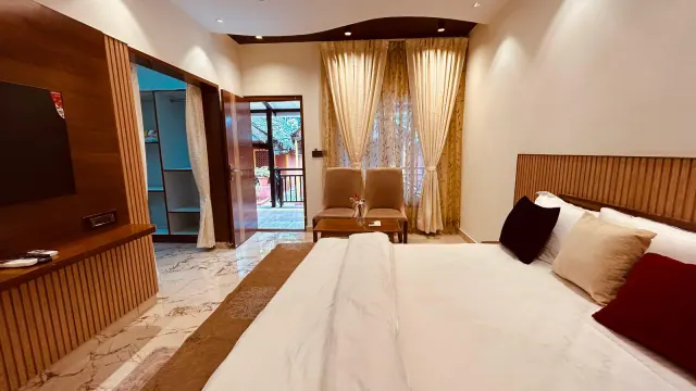 Premium AC Cottage — the bed facing the door to the balcony