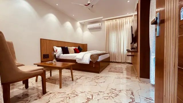 Premium AC Cottage — the room from the doorway, with armchairs and a coffee table