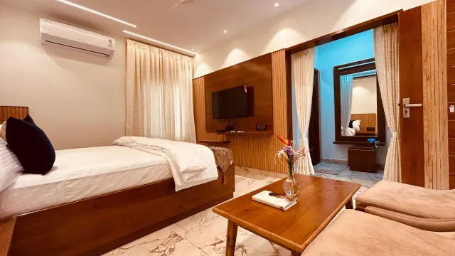 Premium AC Cottage — TV wall and the dressing area beyond